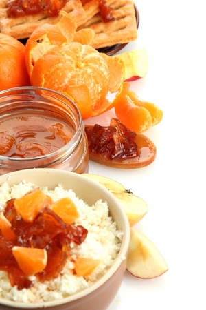 cottage cheese in bowl with homemade tangerine jam, isolated on whiteの写真素材