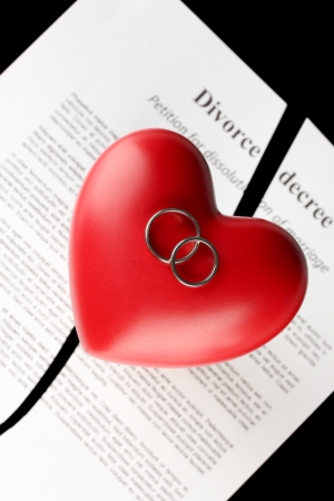 red heart with torn Divorce decree document, on black background close-upの写真素材