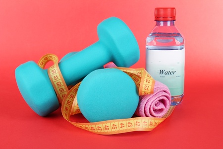 Dumbbells on red backgroundの写真素材