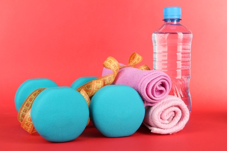 Dumbbells on red backgroundの写真素材
