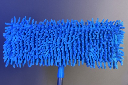 Blue mops for floor on bright backgroundの写真素材