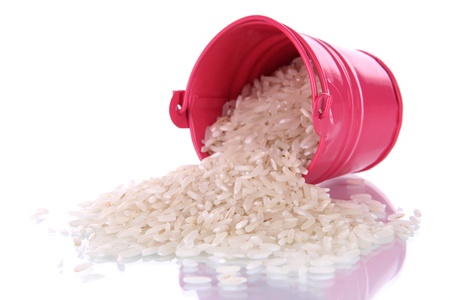 Overturned bucket with grains isolated on whiteの写真素材