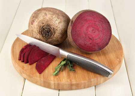 Sliced beetroot on board on wooden table close-up