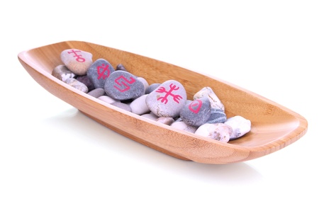 Fortune telling  with symbols on stones in wooden bowl isolated on white