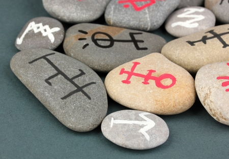 Fortune telling  with symbols on stones on grey backgroundの写真素材