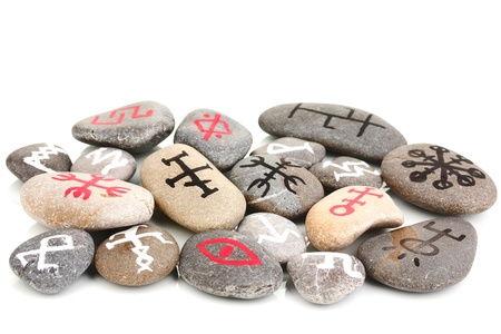 Fortune telling  with symbols on stones isolated on whiteの写真素材