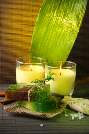 Hand made soap and candles on bamboo mat backgroundの写真素材