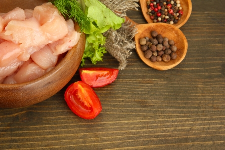 raw chicken meat in bowl, on wooden backgroundの写真素材