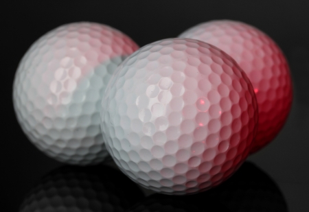 Golf balls on grey backgroundの写真素材