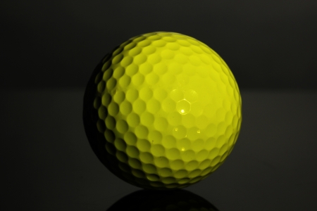 Golf ball on grey backgroundの写真素材