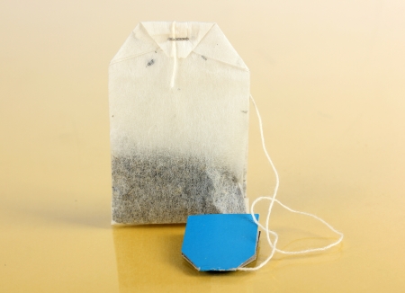 Tea bag on yellow backgroundの写真素材