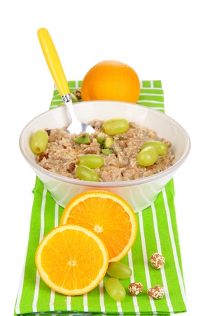 Useful oatmeal in bowl with fruit isolated on whiteの写真素材