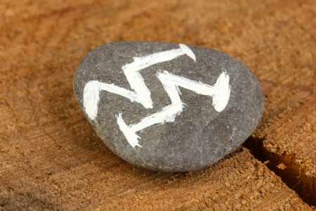 Fortune telling  with symbols on stone on wooden background