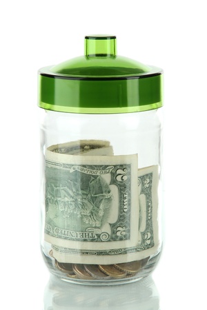 Glass jar with money isolated on whiteの写真素材