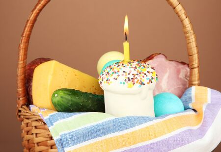 Easter basket: Conceptual photo of traditional easter food in wicker basket, on wooden table on...