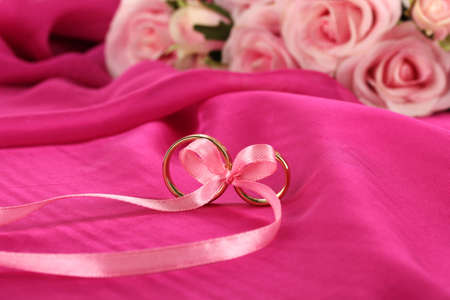 Wedding rings tied with ribbonの写真素材