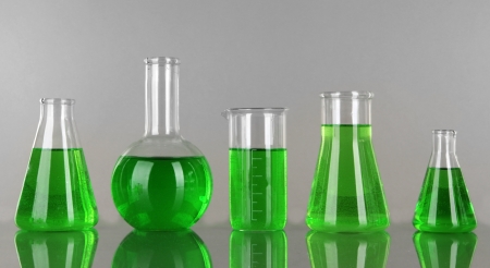 Test-tubes with green liquid on gray backgroundの写真素材
