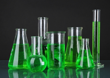 Test-tubes with green liquid on dark gray backgroundの写真素材