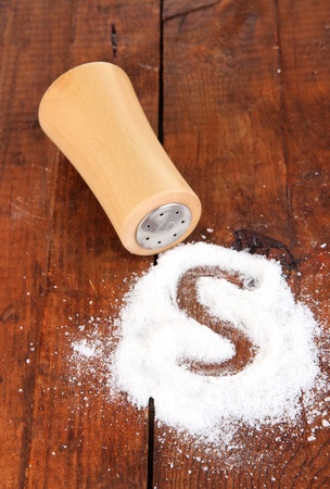 Wooden salt shaker on wooden backgroundの写真素材