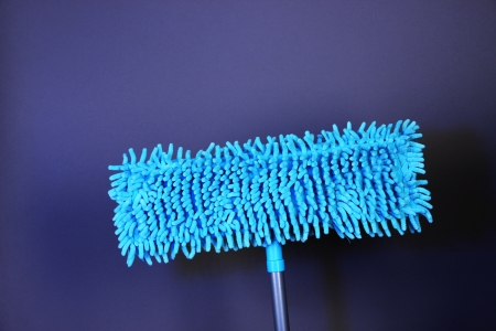 Blue mops for floor on bright background