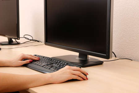 Female hands typing on keyboard
