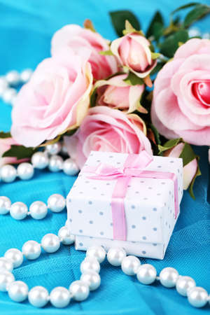 Rose  and gift  on blue clothの写真素材