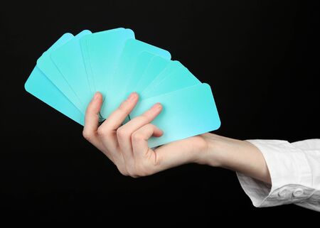 Hand with business cards. Concept: Business like poker game. Isolated on whiteの写真素材