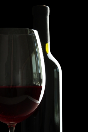 Bottle and glass of wine isolated on blackの写真素材