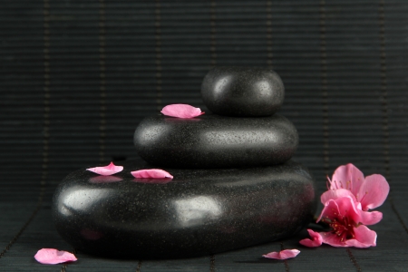 Spa stones and flowers on bamboo backgroundの写真素材