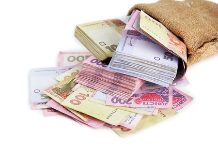Burlap bag with Ukrainian money, isolated on white