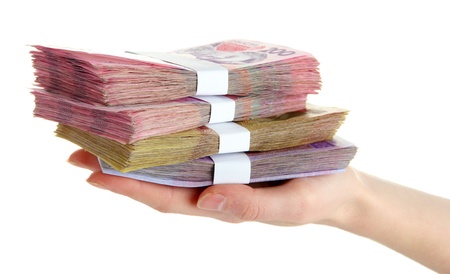 Ukrainian money in hand, isolated on white