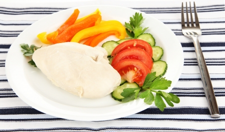 Boiled chicken breast on plate with vegetables close upの写真素材