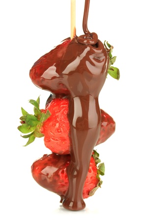 Strawberry dipped in chocolate fondue isolated on whiteの写真素材