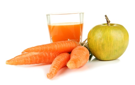 Heap of carrots and green apple, glass of juice, isolated on whiteの写真素材