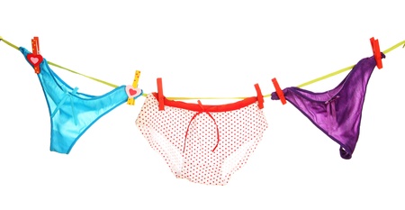 Women's panties hanging on rope isolated on whiteの写真素材