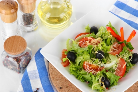 Light salad on plate on napkinの写真素材