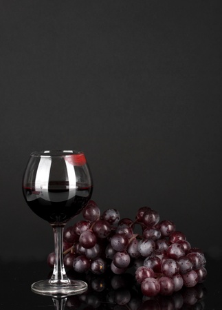 Glass of wine with lipstick imprint on dark backgroundの写真素材