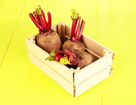 Young beets on wooden box on wooden table close-upの写真素材