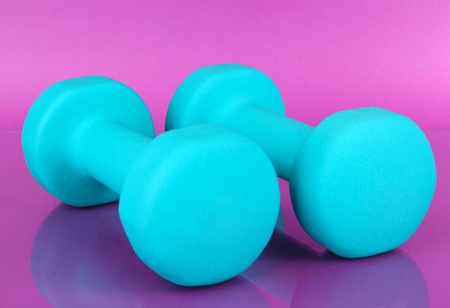 Dumbbells on purple backgroundの写真素材