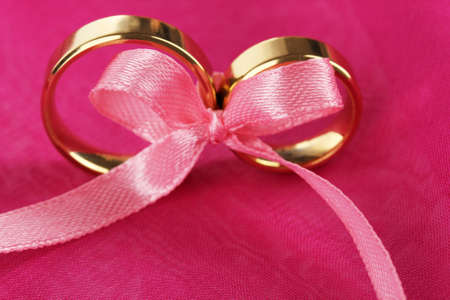 Wedding rings tied with ribbonの写真素材