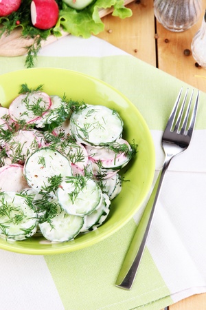 Vitamin vegetable salad in bowl on wooden table close-upの写真素材