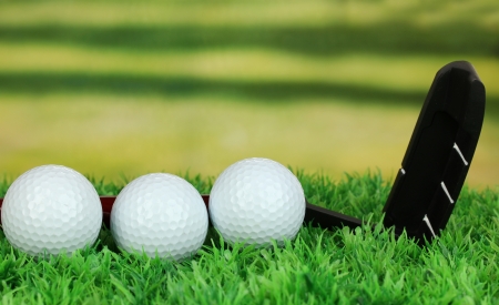 Golf balls and driver on green grass outdoor close upの写真素材