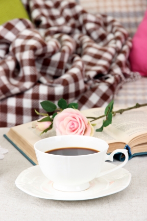 Composition with cup of drink, book and flowers on home interior backgroundの写真素材