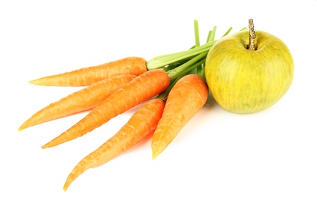 Heap of carrots and green apple, isolated on whiteの写真素材
