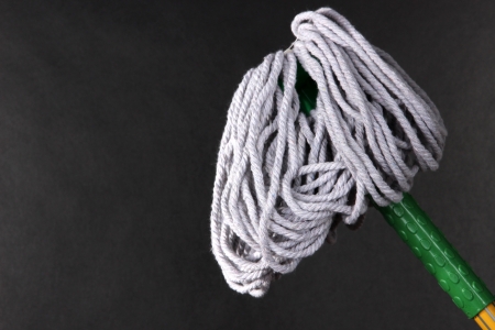 Mop for floor on dark backgroundの写真素材