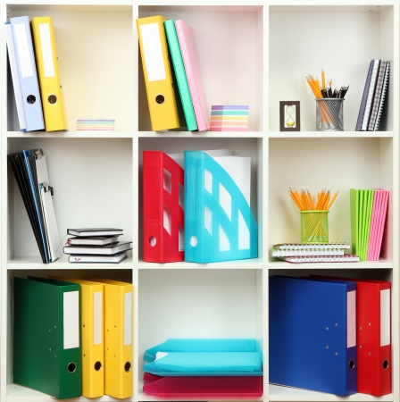White office shelves with different stationery, close upの写真素材