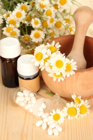 Medicine chamomile flowers on wooden tableの写真素材