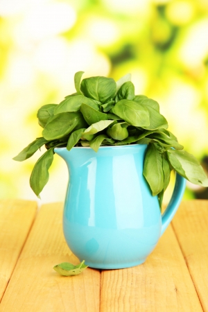 Fresh herb in pitcher on wooden table on natural backgroundの写真素材