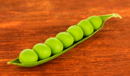 Sweet green peas on wooden backgroundの写真素材