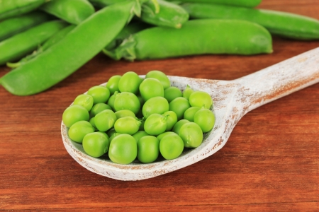 Sweet green peas on wooden backgroundの写真素材